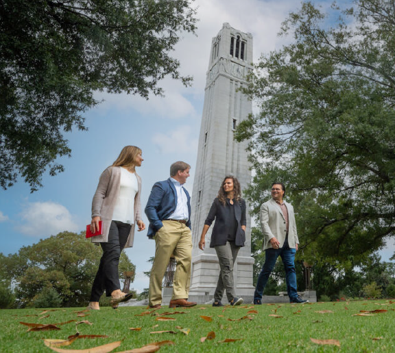 a group of people walking in front of a tower