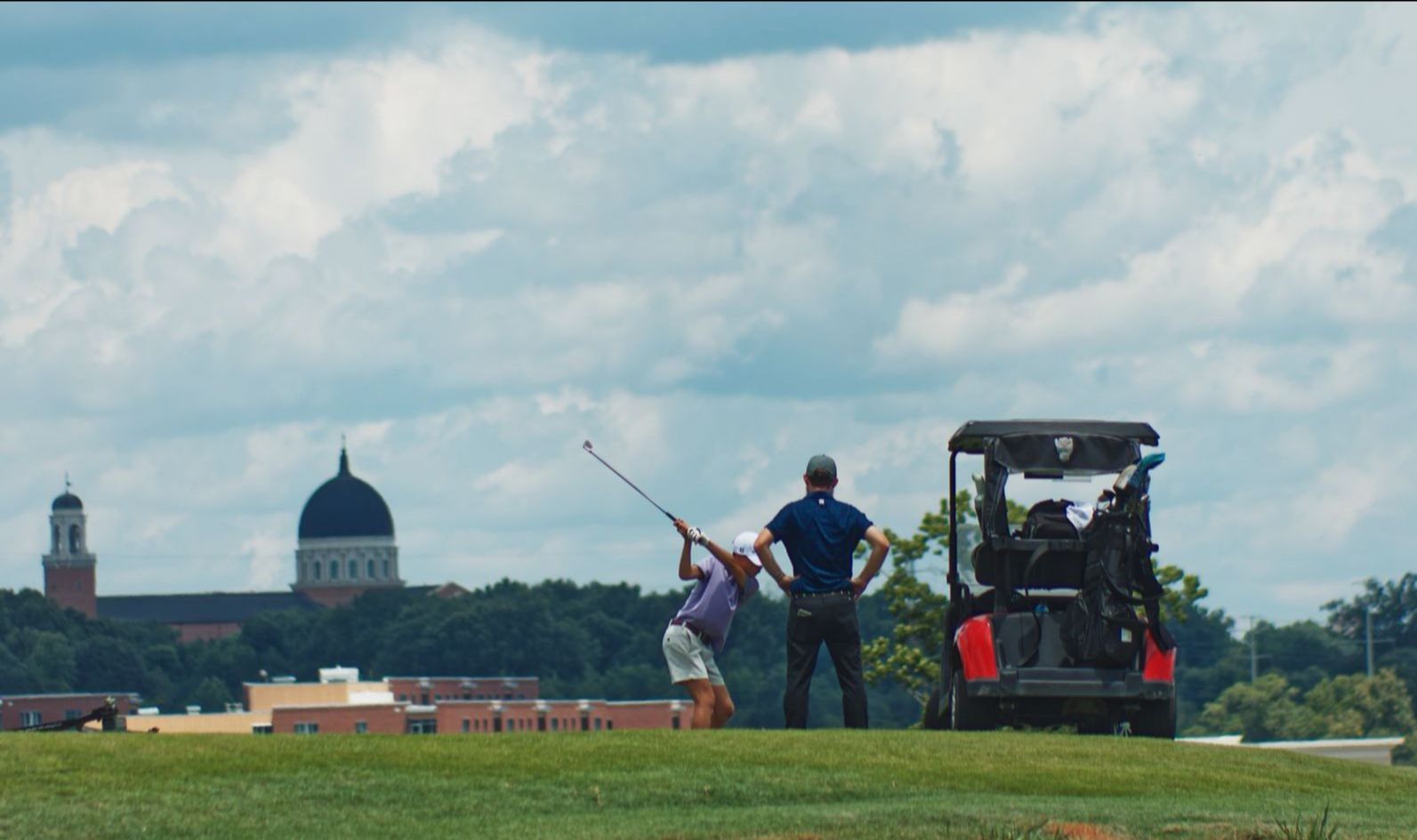 Golfer and caddie on the green at the Lonnie Poole Golf Club.